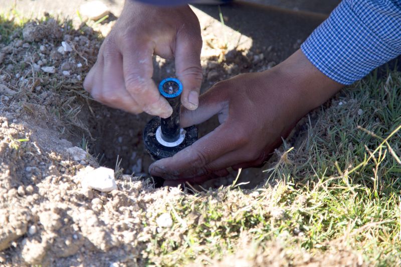 Technician Repairing Sprinkler
